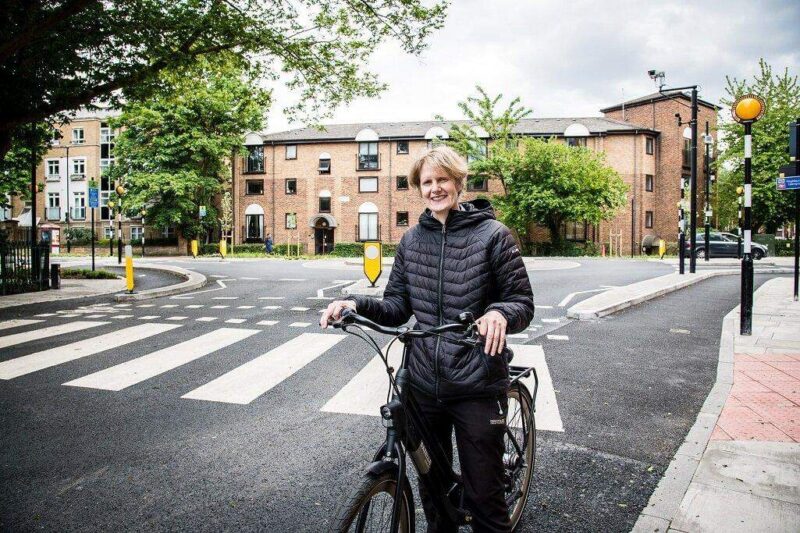 Cllr Champion on her bike by the new continental style roundabout